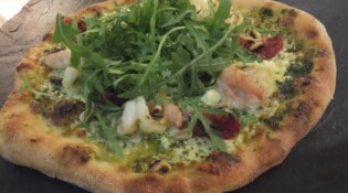 Red Center - la pizza a base de pesto, gambas, tomates confites, pignons, olives et rockette